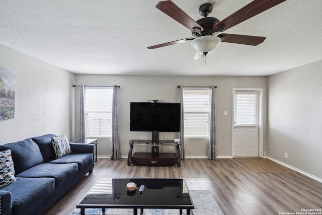 1826 Strawhouse, San Antonio, TX 78245 - living area featuring wood finished floors, ceiling fan, and a textured ceiling