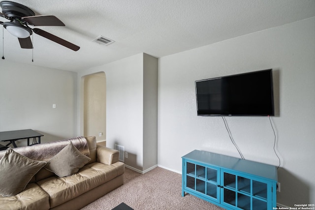 1826 Strawhouse, San Antonio, TX 78245 - living area featuring ceiling fan, carpet flooring, arched walkways, and a textured ceiling