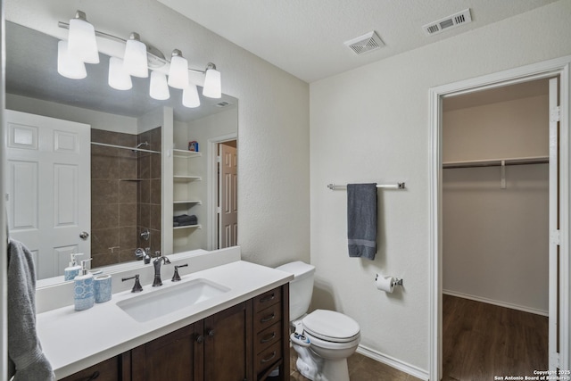 1826 Strawhouse, San Antonio, TX 78245 - full bathroom with vanity, a shower, a walk in closet, and wood finished floors