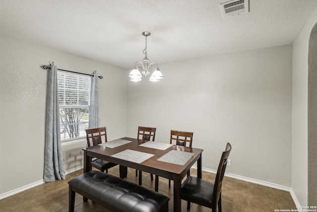 1826 Strawhouse, San Antonio, TX 78245 - dining space featuring a chandelier and dark tile patterned floors