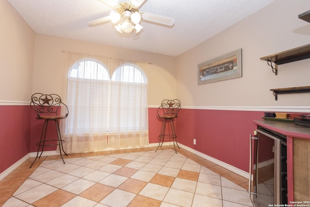 309 Meandering Way, Del Rio, TX 78840 - living area featuring wine cooler, a ceiling fan, a textured ceiling, and tile patterned floors