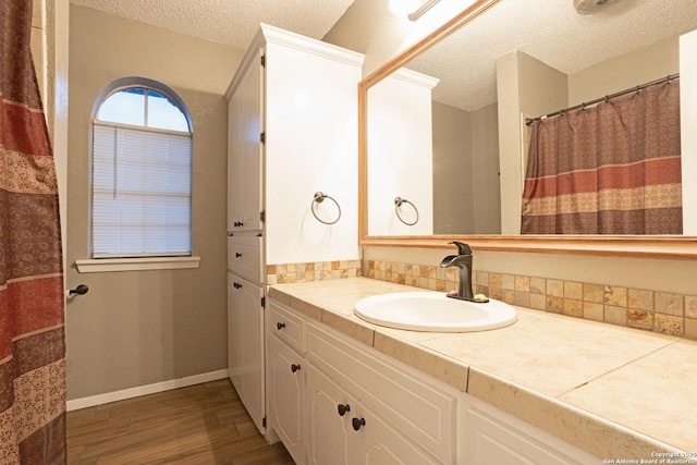 309 Meandering Way, Del Rio, TX 78840 - bathroom with wood finished floors, vanity, and a textured ceiling