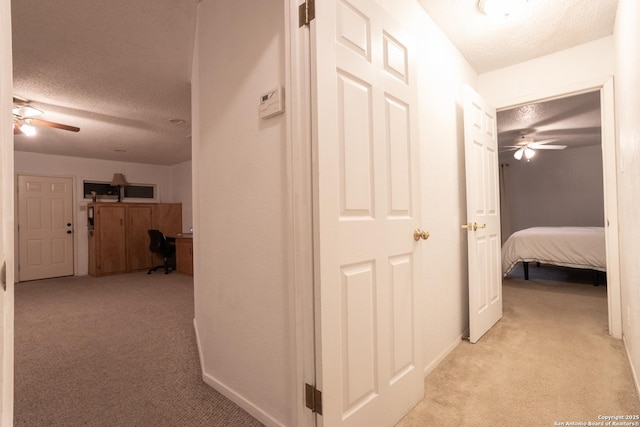 309 Meandering Way, Del Rio, TX 78840 - hallway with a textured ceiling, light carpet, and an office area