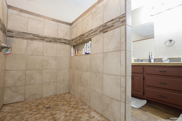 309 Meandering Way, Del Rio, TX 78840 - bathroom featuring vanity, wood finished floors, and a tile shower