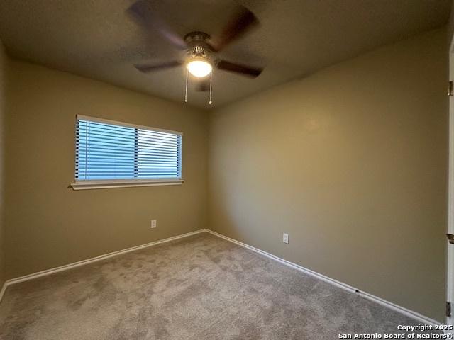 16454 Blanco Ky, San Antonio, TX 78247 - spare room with a ceiling fan and carpet