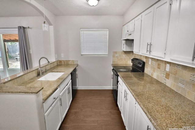 7730 Pipers Vw, San Antonio, TX 78251 - kitchen with black appliances, a peninsula, under cabinet range hood, dark wood-style flooring, and white cabinets