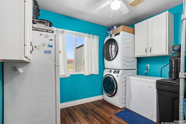 177 Lakeview Cir, La Vernia, TX 78121 - washroom featuring estacked washer and dryer, cabinet space, dark wood-style floors, and ceiling fan