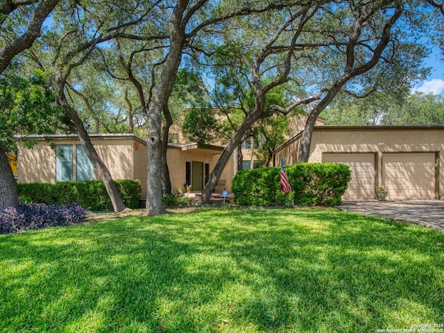 9715 Laurel Oaks, San Antonio, TX 78240 - view of front of house featuring stucco siding, an attached garage, a front yard, and driveway