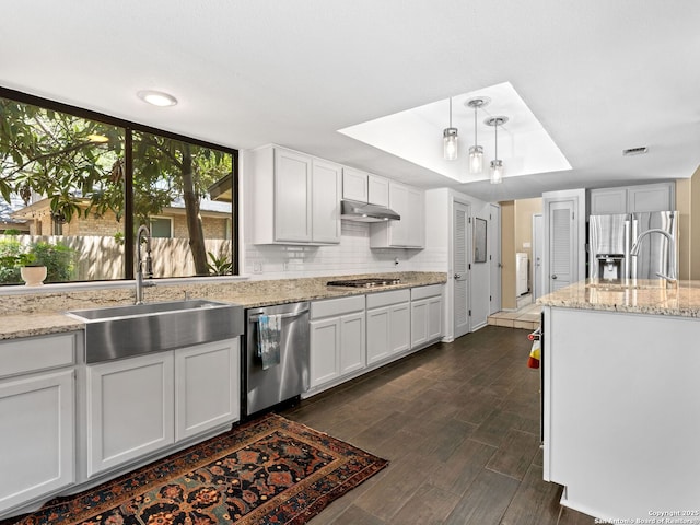 9715 Laurel Oaks, San Antonio, TX 78240 - kitchen with stainless steel appliances, dark wood-style floors, white cabinetry, and washer / dryer