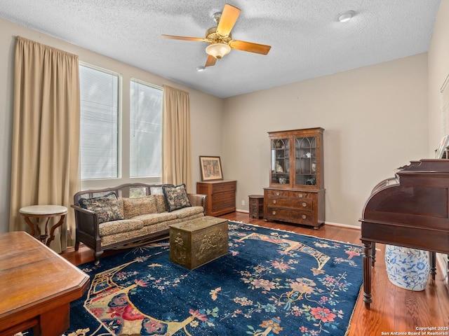 9715 Laurel Oaks, San Antonio, TX 78240 - living area featuring a ceiling fan, wood finished floors, and a textured ceiling