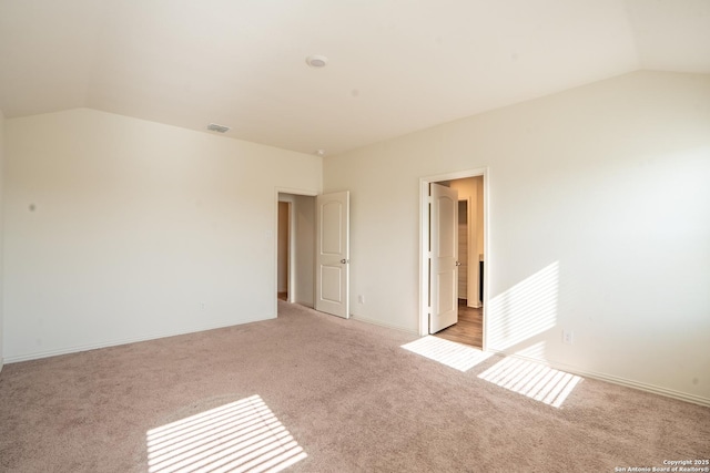 7335 Sharma Vly, San Antonio, TX 78252 - spare room featuring vaulted ceiling and light colored carpet