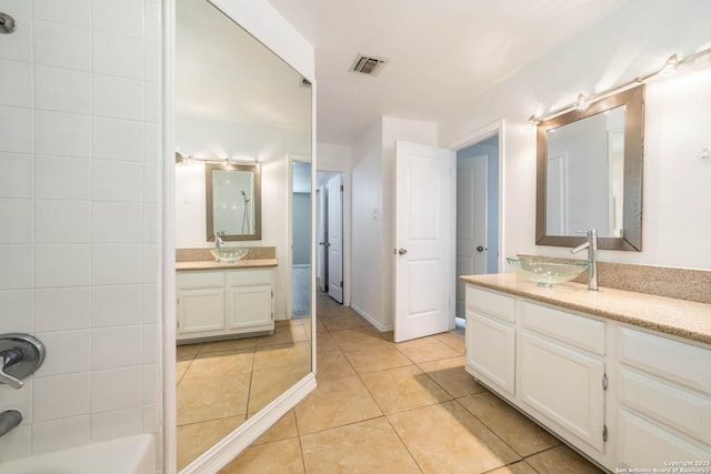 6914 Ludgate, San Antonio, TX 78239 - bathroom with two vanities, tile patterned floors, and bathing tub / shower combination
