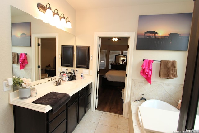 2514 Ladera Bnd, San Antonio, TX 78261 - bathroom featuring connected bathroom, tile patterned floors, a garden tub, vanity, and tile walls