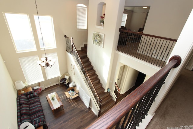 2514 Ladera Bnd, San Antonio, TX 78261 - stairway featuring a chandelier, wood finished floors, and a towering ceiling