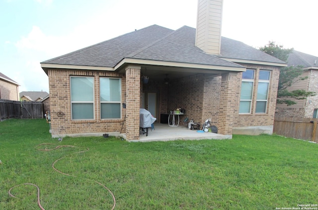 2514 Ladera Bnd, San Antonio, TX 78261 - rear view of property featuring a patio, a fenced backyard, brick siding, and a chimney