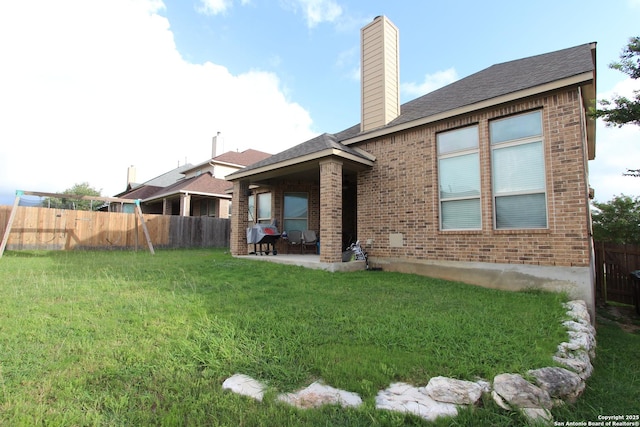 2514 Ladera Bnd, San Antonio, TX 78261 - rear view of property with brick siding, a patio area, a chimney, and a shingled roof