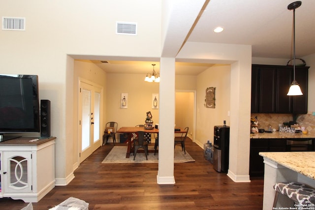 2514 Ladera Bnd, San Antonio, TX 78261 - kitchen featuring dark wood finished floors, a chandelier, decorative backsplash, light stone counters, and recessed lighting