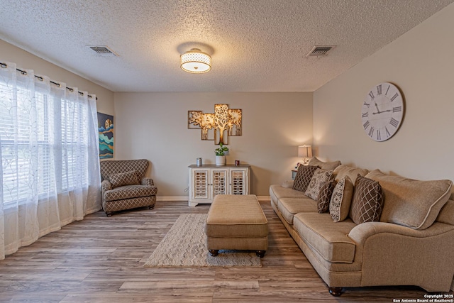 7907 Donshire, Converse, TX 78109 - living room featuring wood finished floors and a textured ceiling