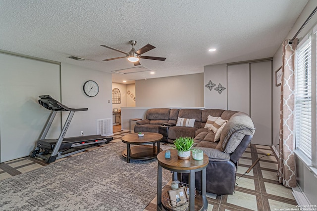 7907 Donshire, Converse, TX 78109 - living area with a textured ceiling, ceiling fan, and recessed lighting