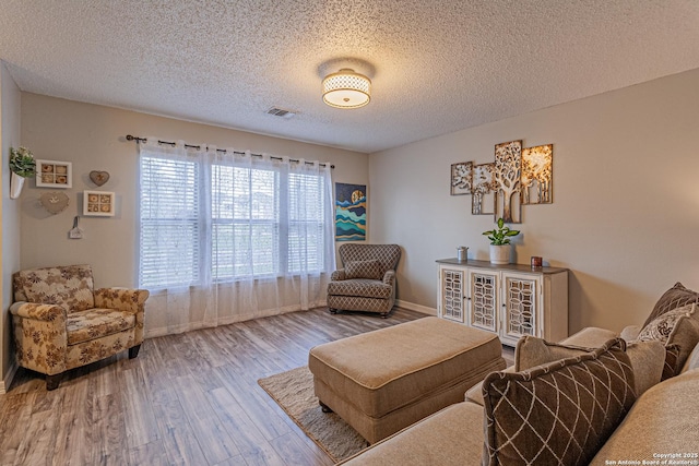 7907 Donshire, Converse, TX 78109 - sitting room featuring wood finished floors and a textured ceiling