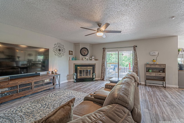 7907 Donshire, Converse, TX 78109 - living area featuring ceiling fan, wood finished floors, a textured ceiling, and a tiled fireplace