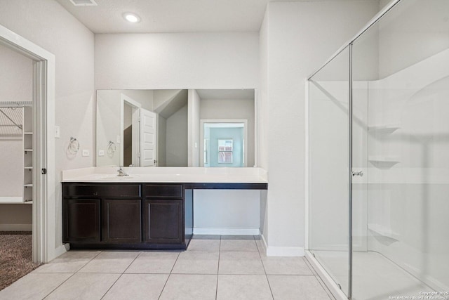 11518 Biddle, San Antonio, TX 78253 - bathroom featuring vanity, a shower stall, a walk in closet, and tile patterned flooring