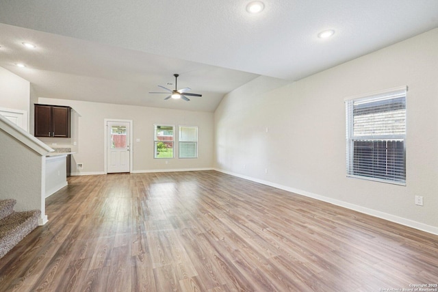 11518 Biddle, San Antonio, TX 78253 - unfurnished living room featuring a ceiling fan, stairs, light wood-type flooring, lofted ceiling, and recessed lighting