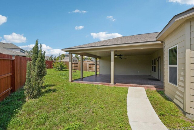11518 Biddle, San Antonio, TX 78253 - fenced backyard with ceiling fan and a patio area