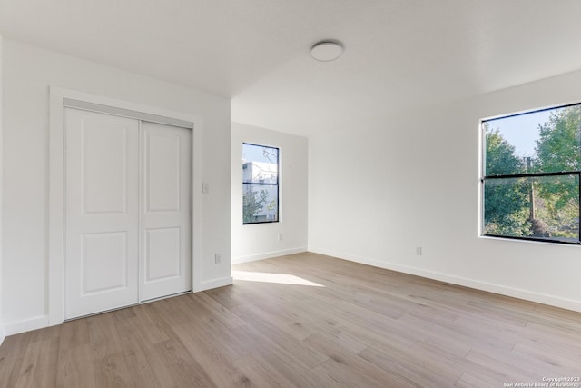 510 S Olive St Unit 101, San Antonio, TX 78203 - unfurnished bedroom featuring light wood-type flooring and a closet