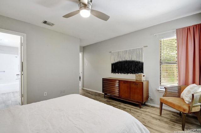 7259 Sunlit Trl, San Antonio, TX 78244 - bedroom featuring wood finished floors, multiple windows, and ensuite bath