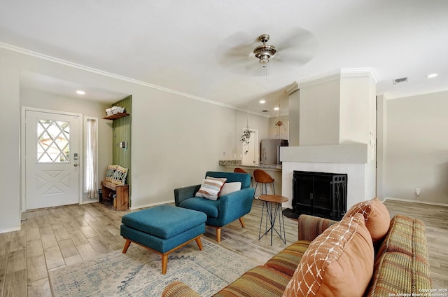 7259 Sunlit Trl, San Antonio, TX 78244 - living area featuring ornamental molding, wood finished floors, ceiling fan, a fireplace, and recessed lighting