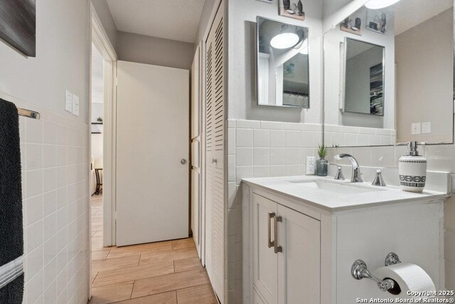 923 Vance Jackson, San Antonio, TX 78201 - bathroom with tile walls, vanity, and wood finish floors