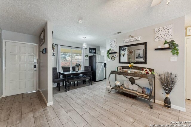 923 Vance Jackson, San Antonio, TX 78201 - foyer featuring wood finish floors and a textured ceiling