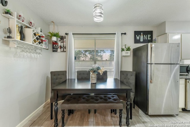 923 Vance Jackson, San Antonio, TX 78201 - dining space featuring wood tiled floors and a textured ceiling
