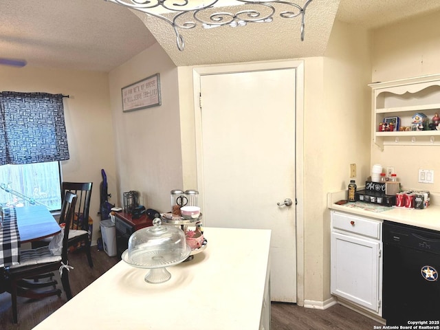 11733 Spring Rdg, San Antonio, TX 78249 - kitchen featuring dishwasher, dark wood finished floors, light countertops, a textured ceiling, and white cabinets