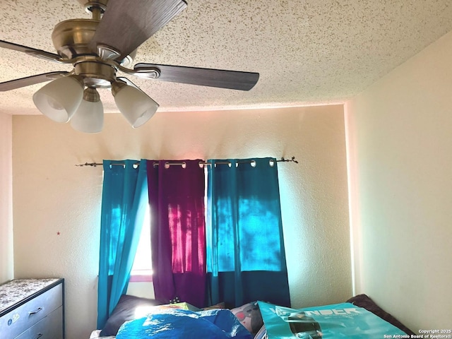 11733 Spring Rdg, San Antonio, TX 78249 - bedroom featuring ceiling fan, a textured wall, and a textured ceiling