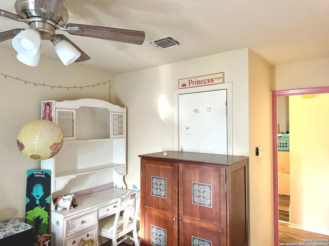 11733 Spring Rdg, San Antonio, TX 78249 - bedroom with a textured ceiling, wood finished floors, and ceiling fan