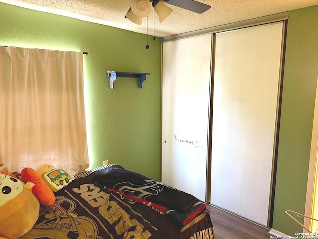 11733 Spring Rdg, San Antonio, TX 78249 - bedroom with wood finished floors, a ceiling fan, and a closet