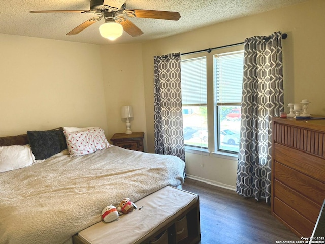11733 Spring Rdg, San Antonio, TX 78249 - bedroom featuring dark wood-style flooring, ceiling fan, and a textured ceiling