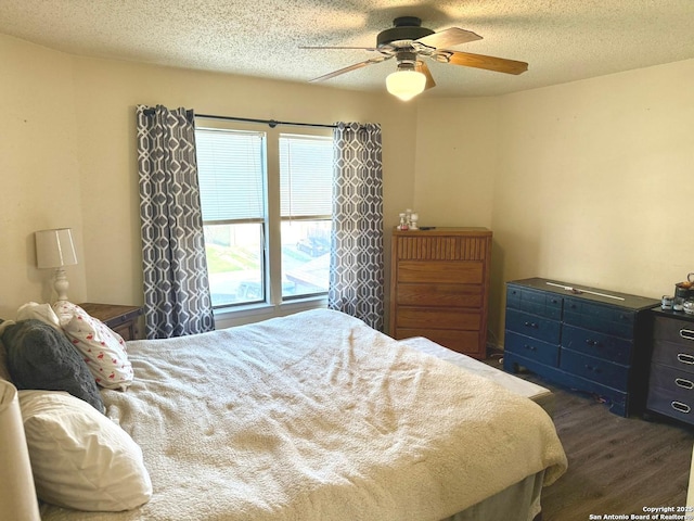11733 Spring Rdg, San Antonio, TX 78249 - bedroom featuring dark wood-style floors, a textured ceiling, and ceiling fan