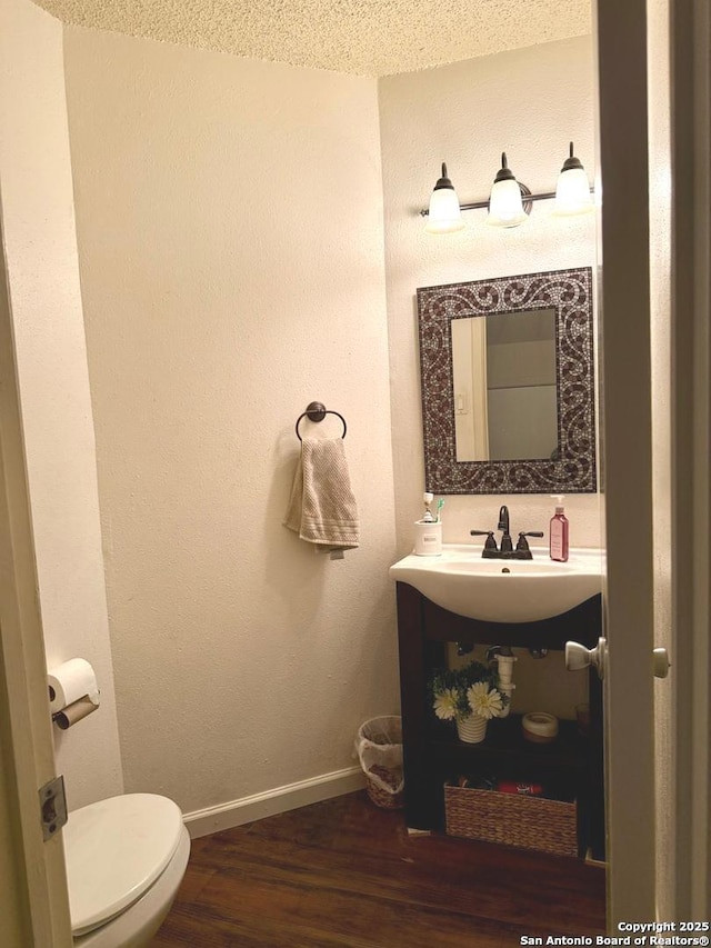 11733 Spring Rdg, San Antonio, TX 78249 - bathroom with wood finished floors and toilet