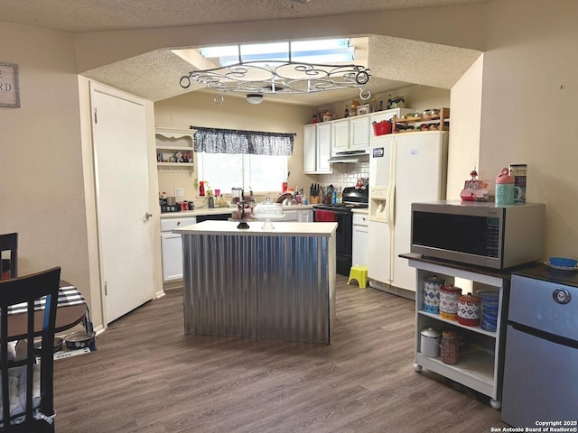 11733 Spring Rdg, San Antonio, TX 78249 - kitchen featuring electric range, stainless steel microwave, open shelves, white refrigerator with ice dispenser, and fridge