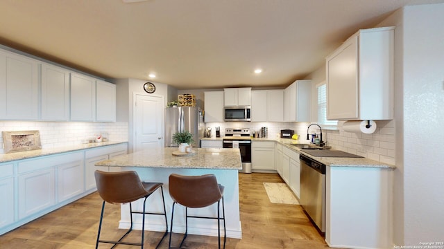 408 River Sta, Cibolo, TX 78108 - kitchen featuring stainless steel appliances, tasteful backsplash, light wood finished floors, white cabinetry, and recessed lighting