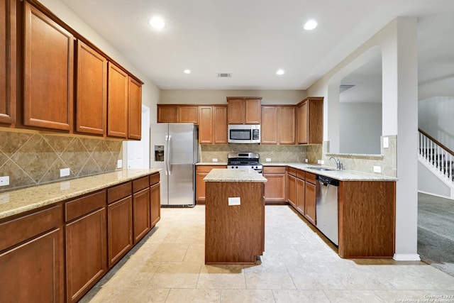 11708 Northern Star, Schertz, TX 78154 - kitchen with appliances with stainless steel finishes, a kitchen island, brown cabinets, light stone countertops, and recessed lighting