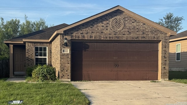 6322 Channel Vw, San Antonio, TX 78222 - view of front of property featuring concrete driveway, brick siding, and a garage
