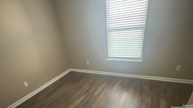6322 Channel Vw, San Antonio, TX 78222 - unfurnished room with dark wood-style floors and baseboards