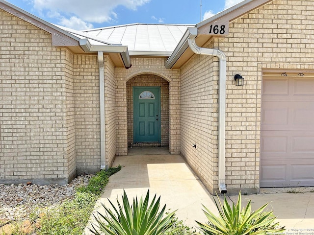 168 Great Oaks Blvd, La Vernia, TX 78121 - property entrance with a garage and brick siding