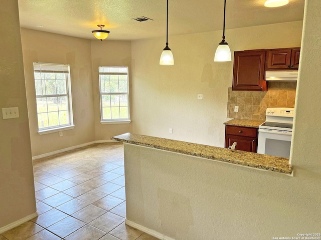 168 Great Oaks Blvd, La Vernia, TX 78121 - kitchen featuring white electric range, under cabinet range hood, pendant lighting, light tile patterned flooring, and light stone countertops
