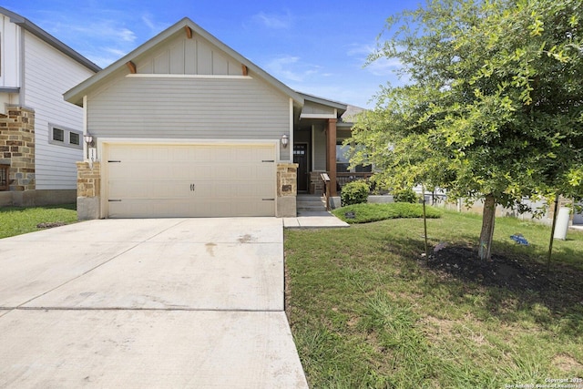 11631 Troubadour, San Antonio, TX 78245 - view of front of home with board and batten siding, a front lawn, concrete driveway, covered porch, and an attached garage