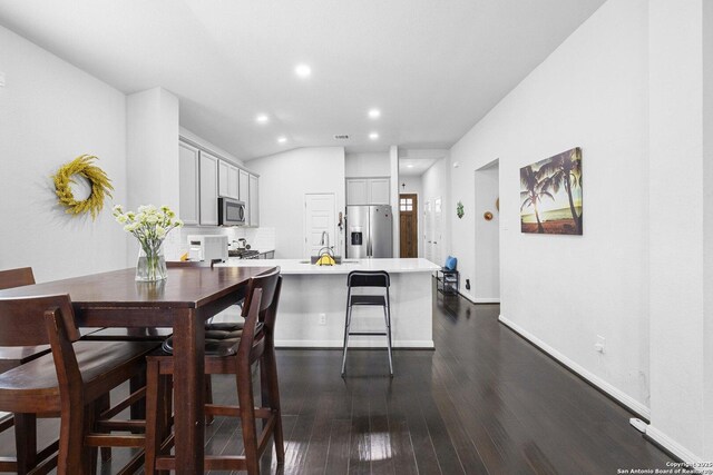 11631 Troubadour, San Antonio, TX 78245 - kitchen with appliances with stainless steel finishes, a peninsula, recessed lighting, dark wood-style flooring, and light countertops